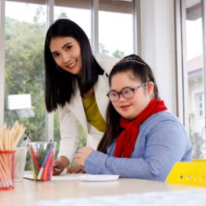 Teacher,And,Girl,With,Down's,Syndrome,In,Art,Class,At