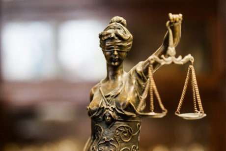 Bronze Lady Justice statue with blindfold and scales.