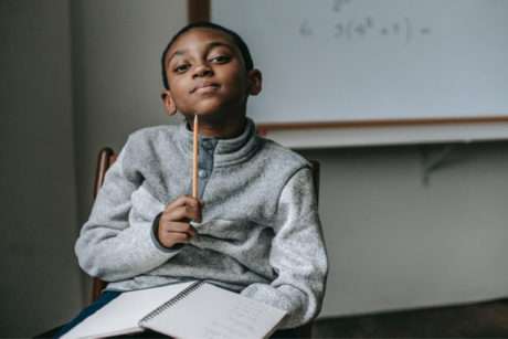 Student contemplating a math problem with a pencil representing critical thinking and academic focus