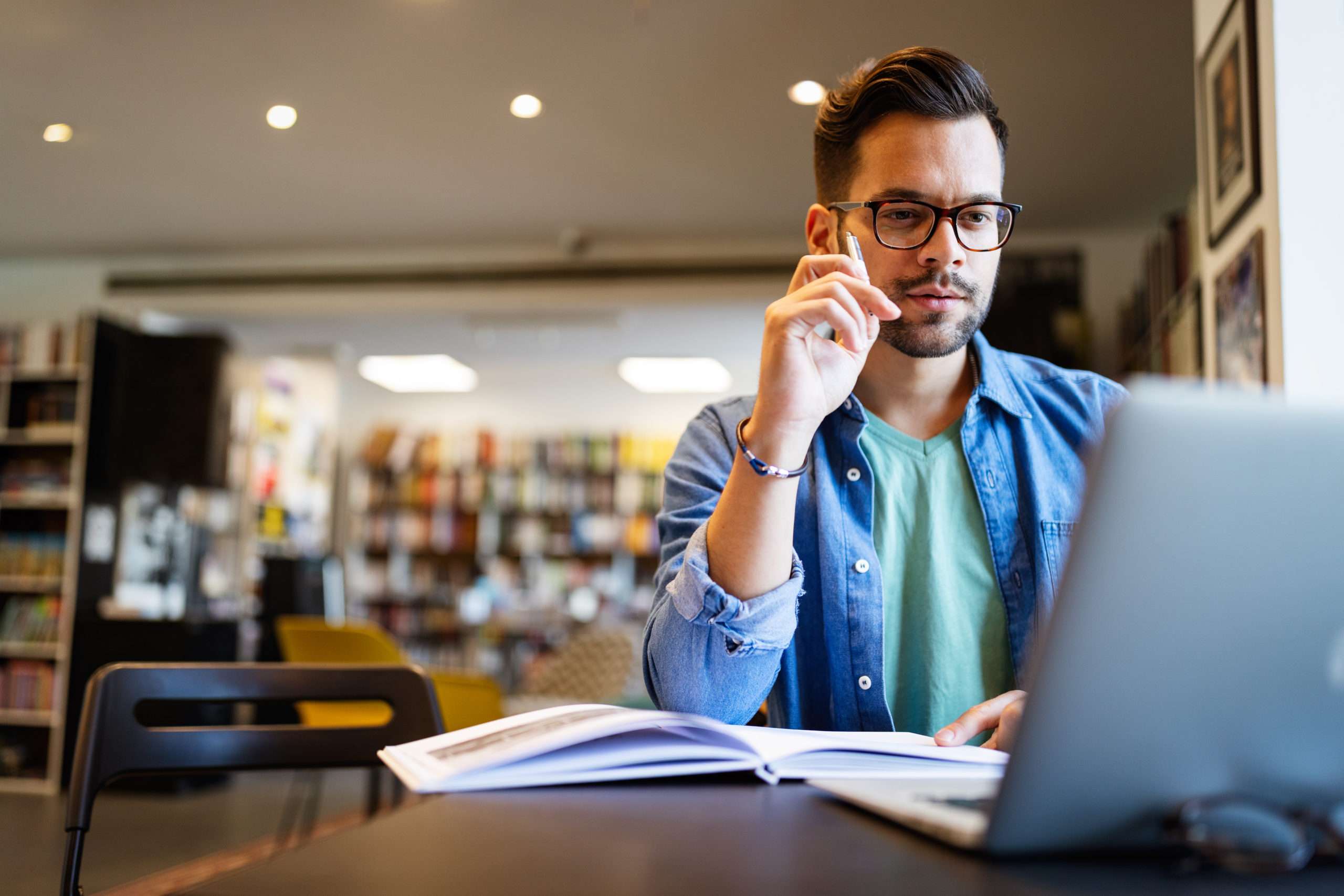 Student preparing exam and learning lessons in school library