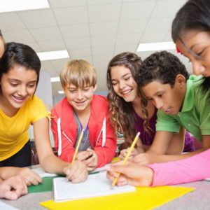 Group of middle school students working on project together