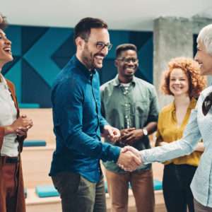 Smiling business persons shaking hands