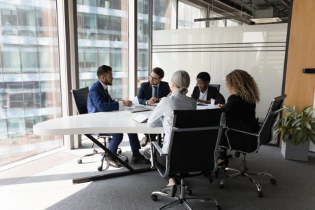 Millennial diverse different aged business team meeting in modern office space.