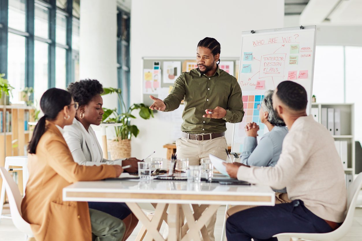 Business, black man or presentation with team, corporate training or conversation for sales growth or planning. African American male leader, employee or teamwork for charts, manager or collaboration