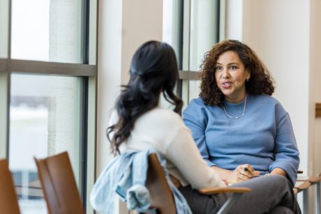 The female supervisor meets with her mid adult female employee to mentor her regarding a new position she is interested in within the company.
