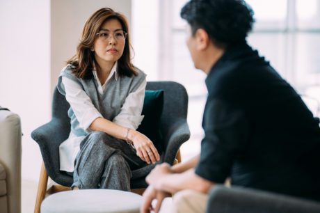 School counselor or coach providing individual support to a student or staff member