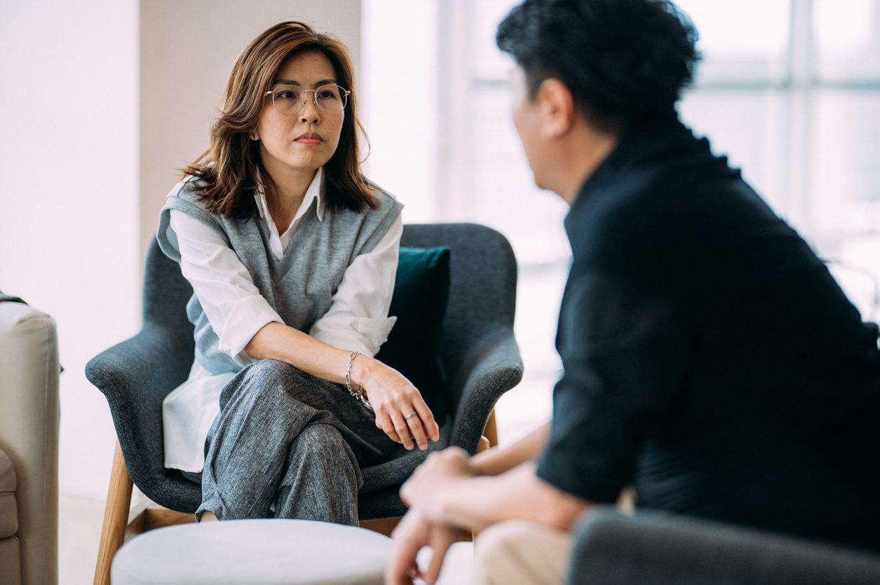 School counselor or coach providing individual support to a student or staff member
