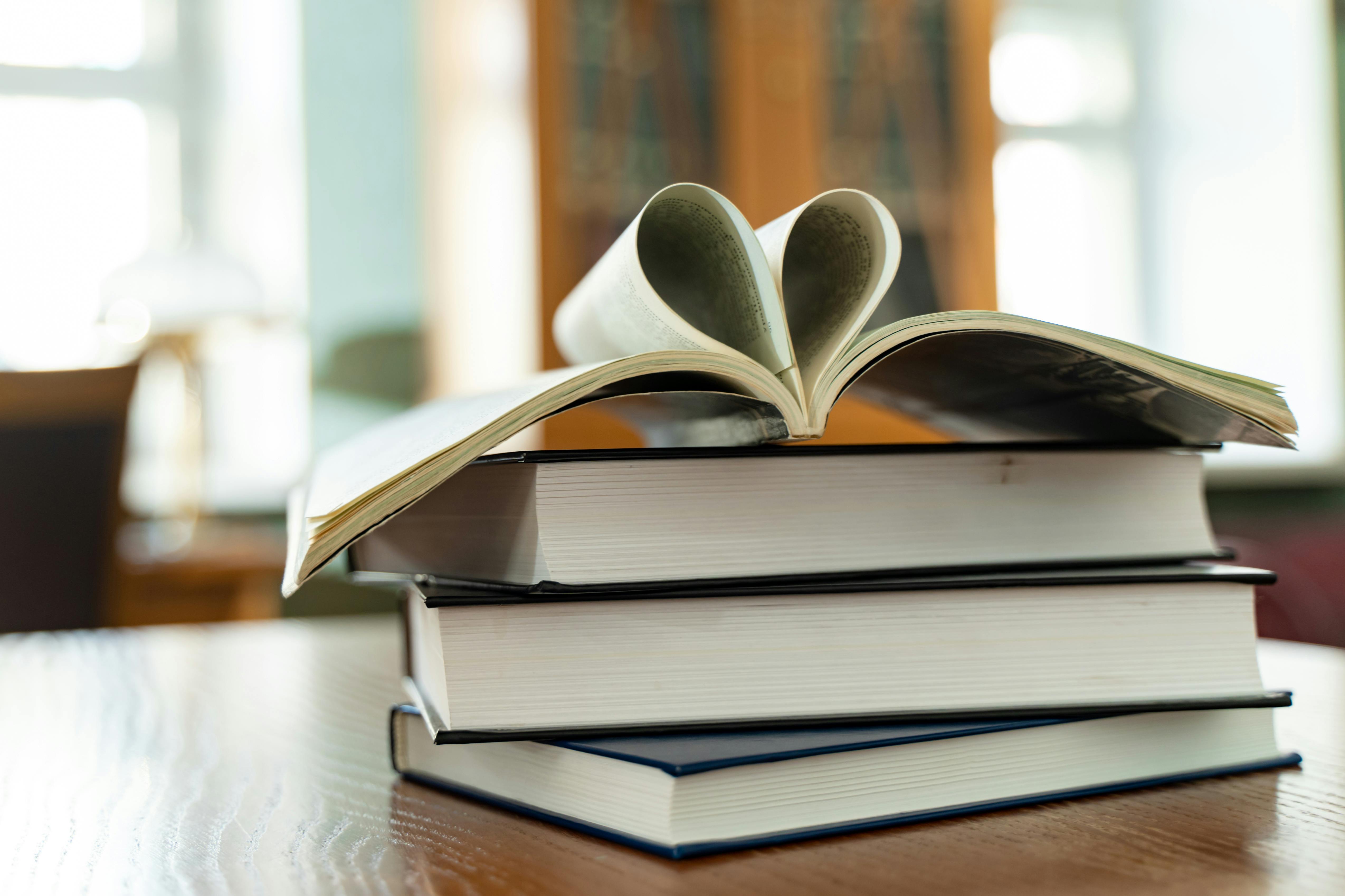 Books forming a heart, promoting a positive and nurturing learning environment in schools