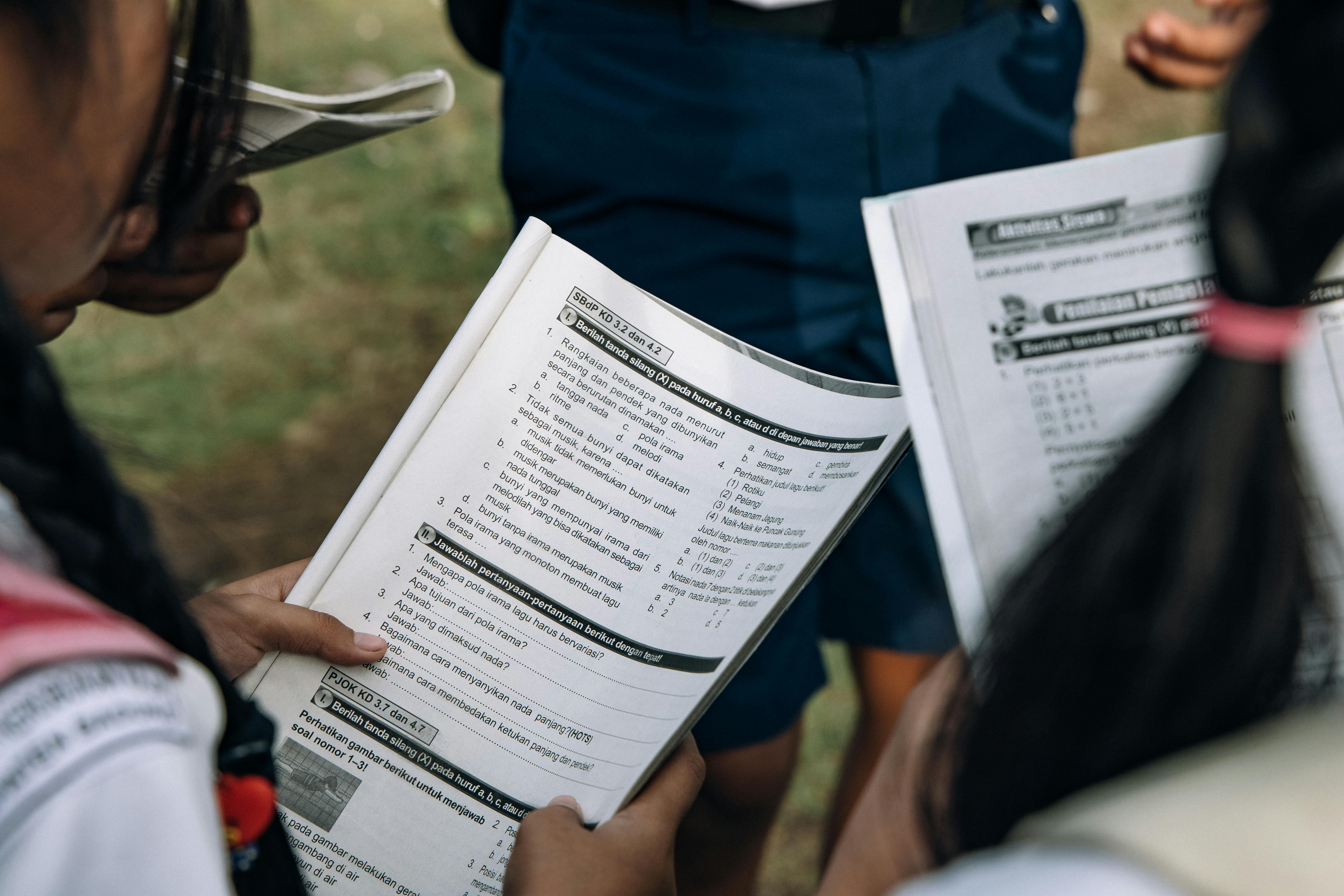 Students reviewing curriculum materials or taking an assessment, representing academic programs